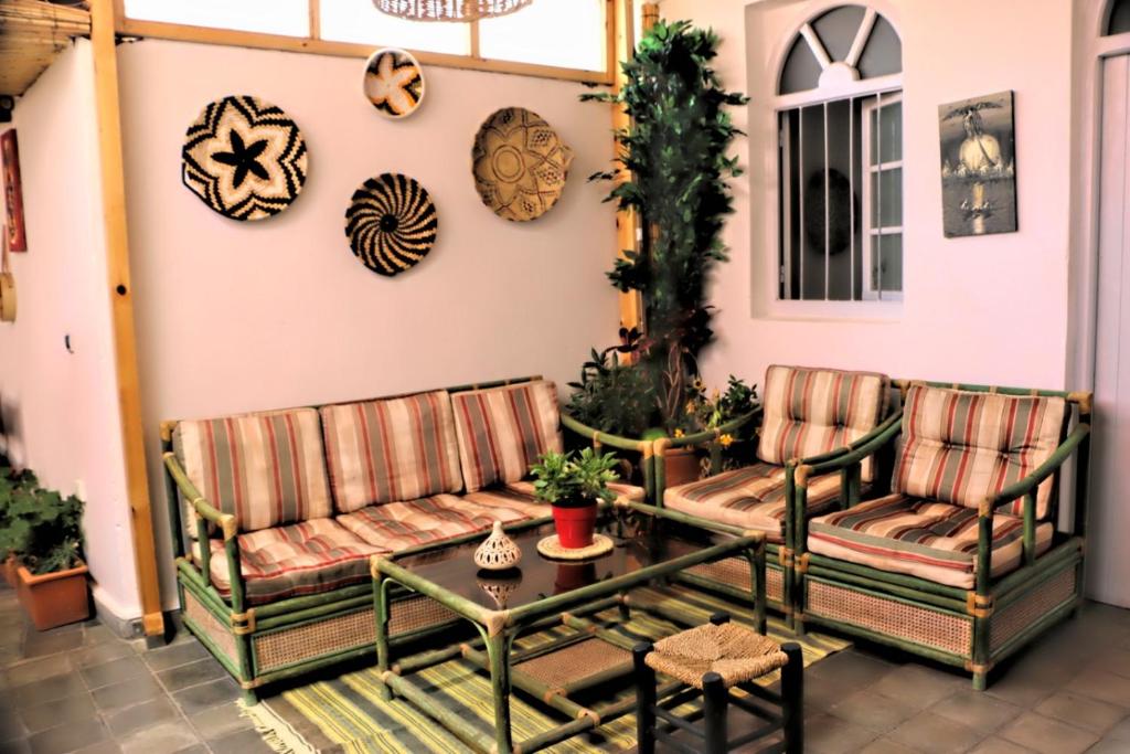 a patio with two benches and a table at Art house in El Jadida