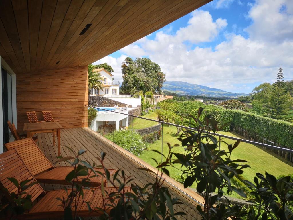 a view from a balcony of a house with a view of the ocean at Quinta das Camélias - Açores in Ponta Delgada