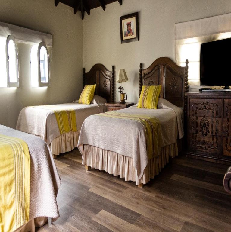 Postel nebo postele na pokoji v ubytování Hotel Antigua Miraflores