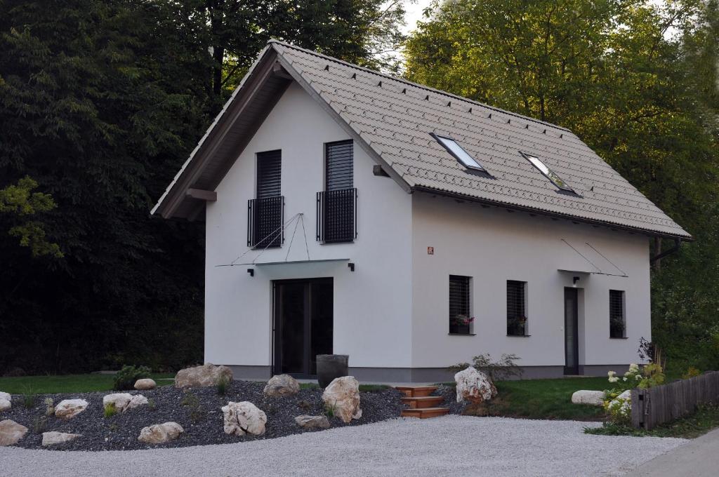 a white house with black windows and a driveway at Brand new house Luna in Bled