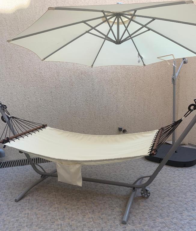 a hammock and an umbrella in a room at Minka in Kotor