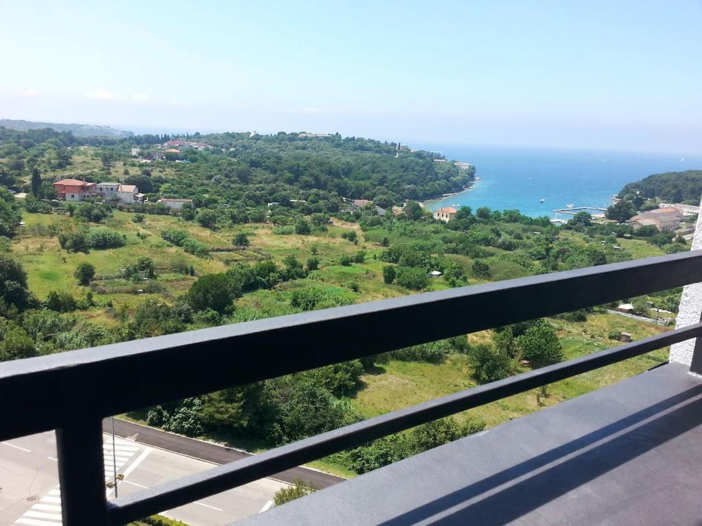 a view of the ocean from the balcony of a house at sky in Pula