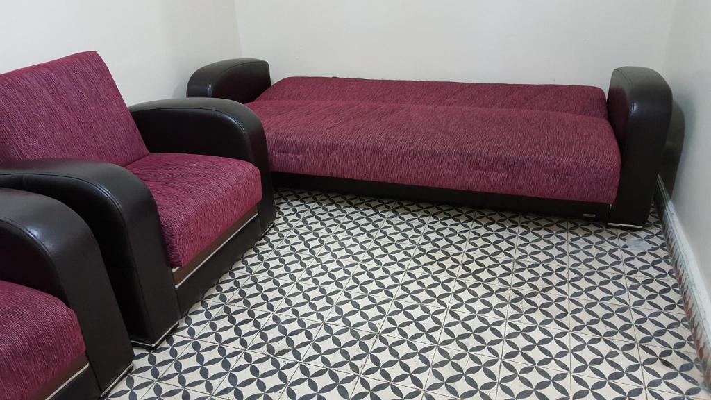 a couch and two chairs in a room at Houria App Sidi Bernoussi in Casablanca