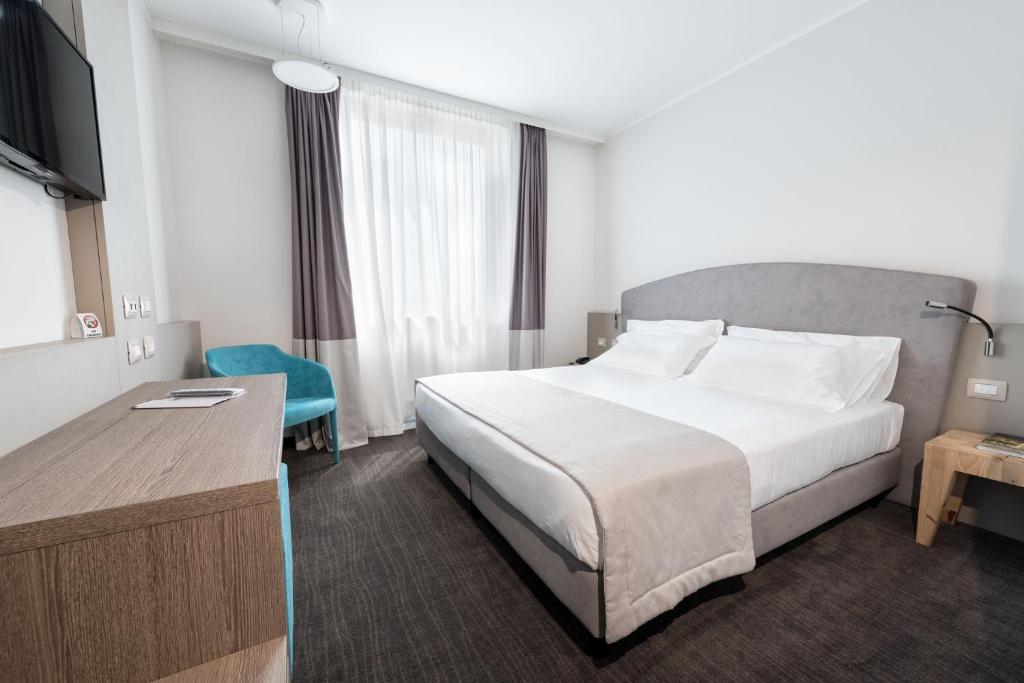 Postel nebo postele na pokoji v ubytování DB Hotel Verona Airport Congress & Spa