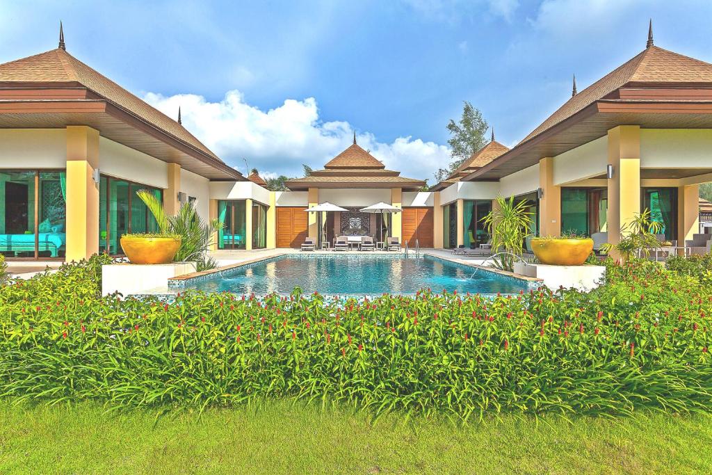 a house with a swimming pool in front of it at Ataman Luxury Villas SHA Plus in Ko Kho Khao