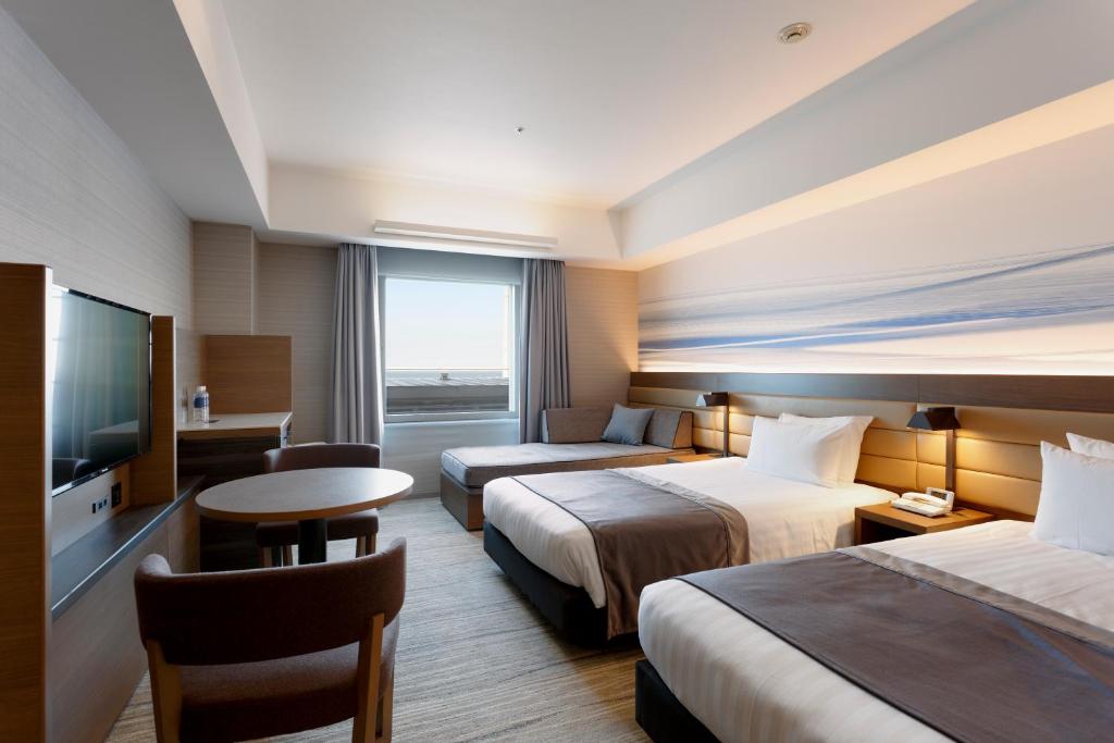 a hotel room with two beds and a television at Haneda Excel Hotel Tokyu Haneda Airport Terminal 2 in Tokyo