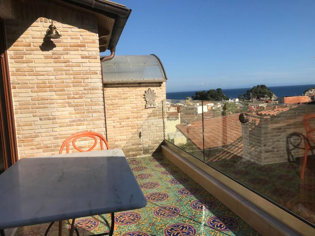 a table and chairs on a balcony with a view at Leda Suites in Parga