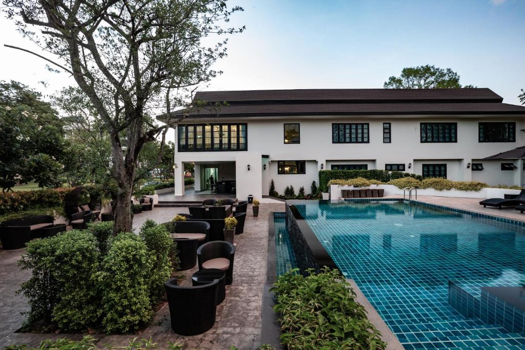 A landscaped outdoor pool beside the hotel building.
