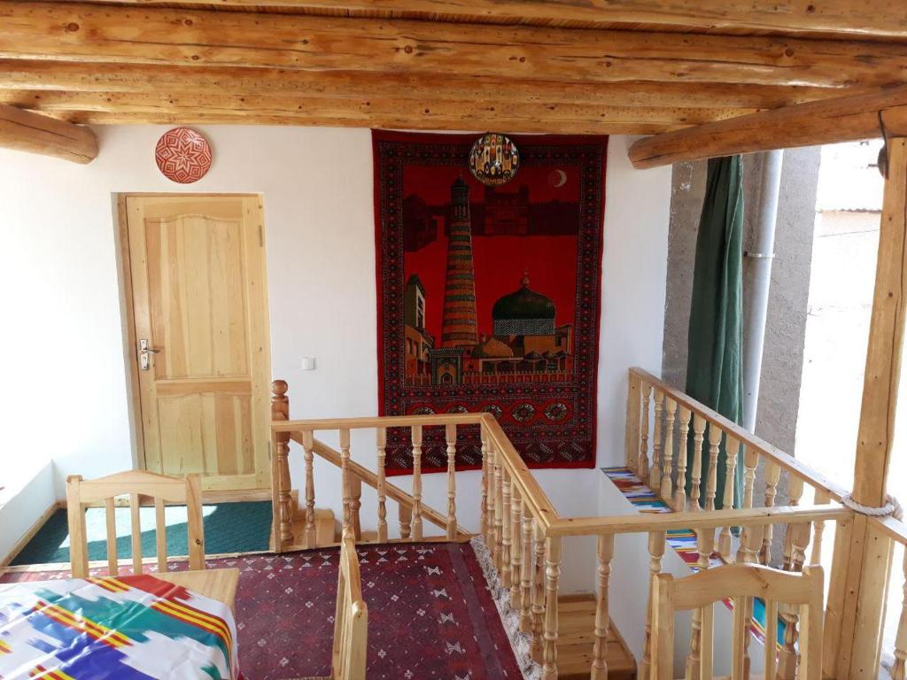 a room with a staircase and a painting on the wall at KHIVA ABDULLA Guest House in Khiva