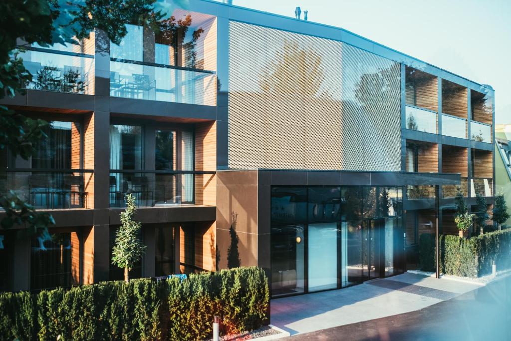 an office building with a glass facade at Hotel Kowald Loipersdorf in Loipersdorf bei Fürstenfeld