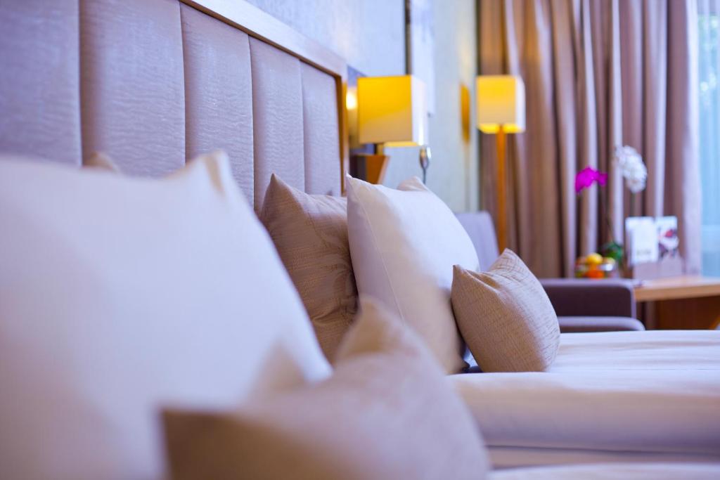 A bed or beds in a room at The Parma Hotel & Spa Taksim