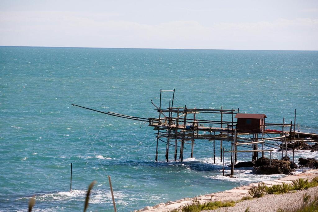 a wooden structure in the water near the ocean at Hotel Levante in Fossacesia