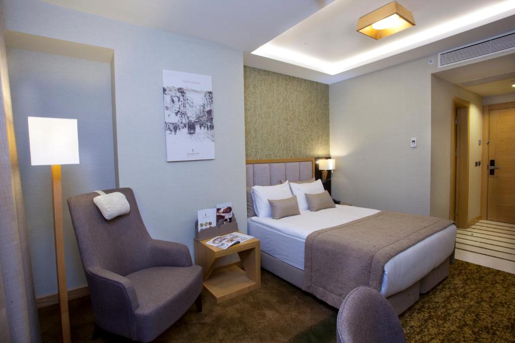 A bed or beds in a room at The Parma Hotel & Spa Taksim