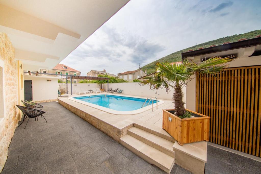 a swimming pool in the backyard of a house at Bella Vista Suites in Vis