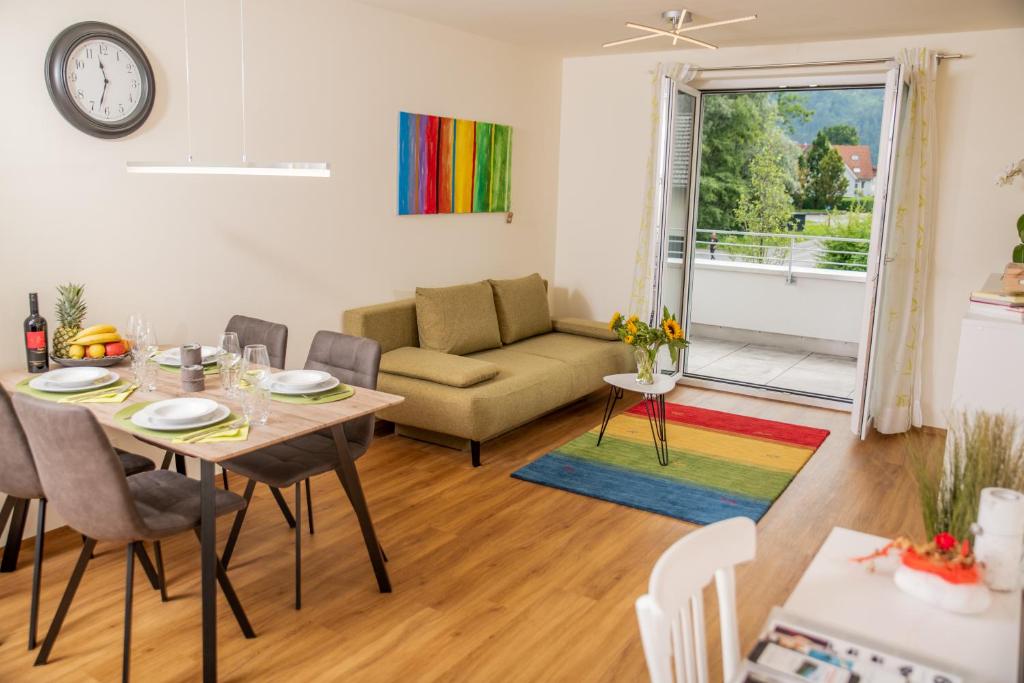 a living room with a table and a couch at Cityapartment Dornbirn 50 qm in Dornbirn