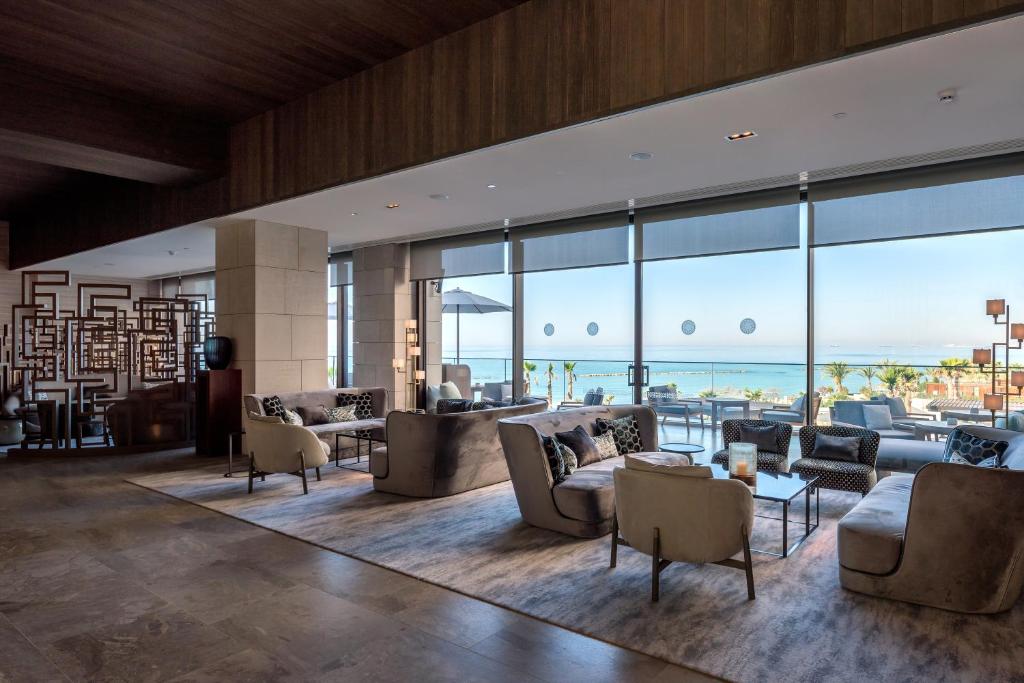 a living room with couches and a view of the ocean at Amara - Sea Your Only View™ in Limassol