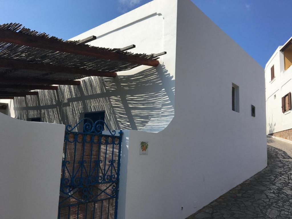 a white building with a gate and a roof at Villa in Panarea - Nespolo in Panarea