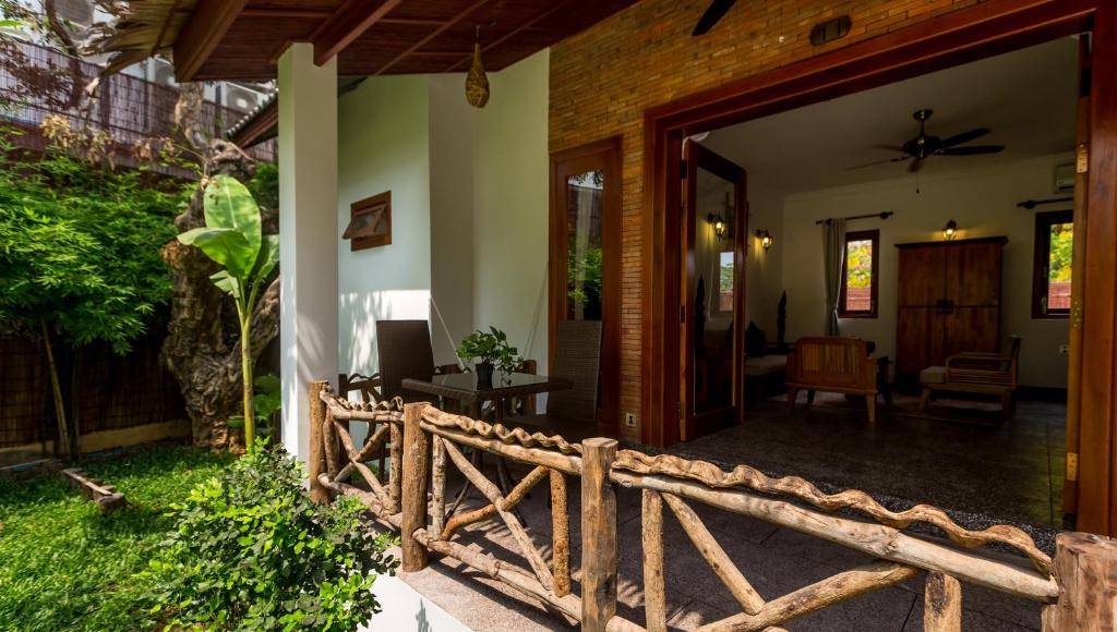 an entrance to a house with a wooden fence at La Rivière d' Angkor Resort in Siem Reap