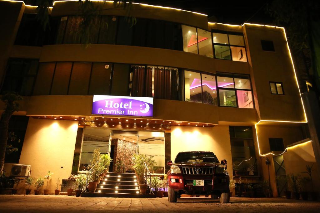 a hotel with a car parked in front of it at Premier Inn Gulberg Lahore in Lahore