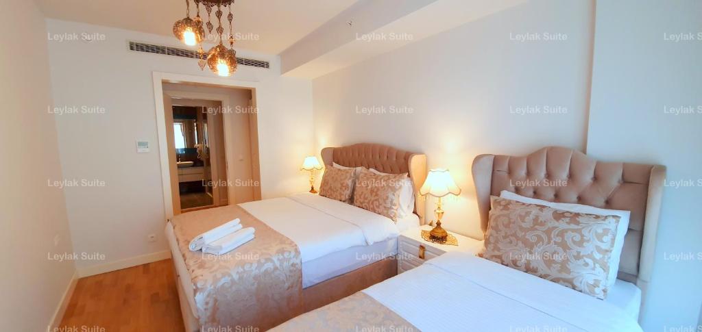 a bedroom with two beds and a mirror at Taksim leylak suite in Istanbul