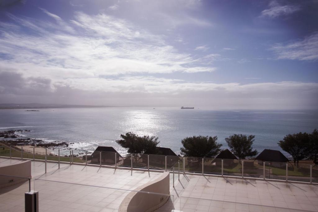 a view of the ocean with a ship in the distance at Nautica 503 in Mossel Bay