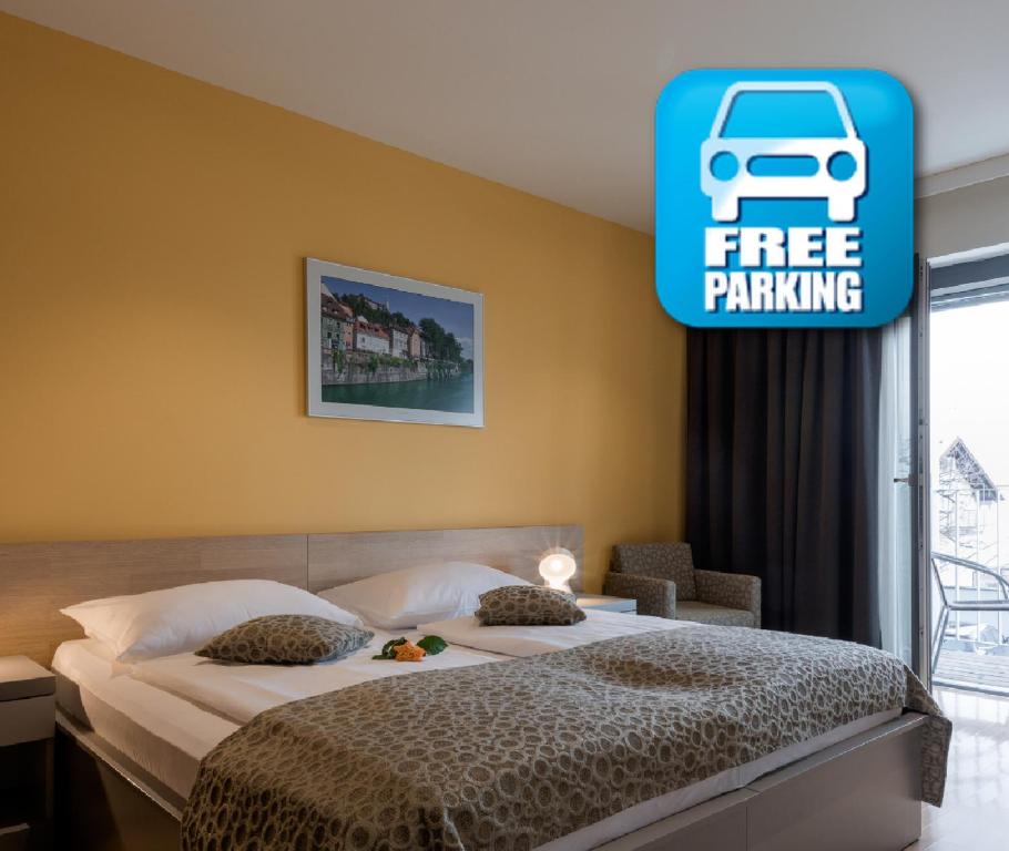 a bedroom with a bed with a free parking sign on the wall at Hotel Florjančkov Hram in Ljubljana