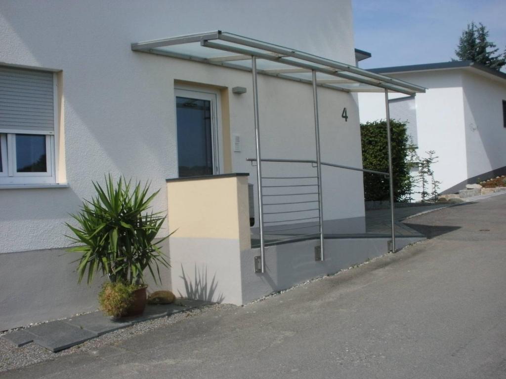 a house with a metal railing on the side of it at roggele bei beck in Stetten