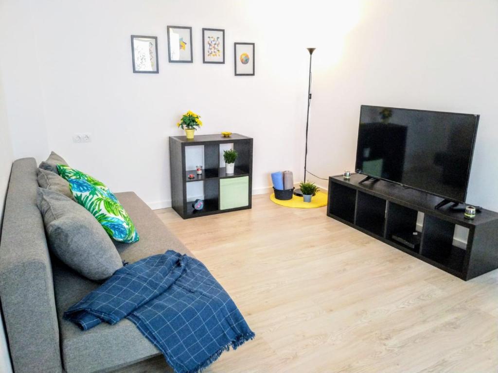 un soggiorno con divano e TV a schermo piatto di Islas Canarias Apartment a Valencia