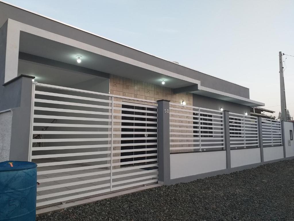 a building with a gate and a fence at Beach House in Penha