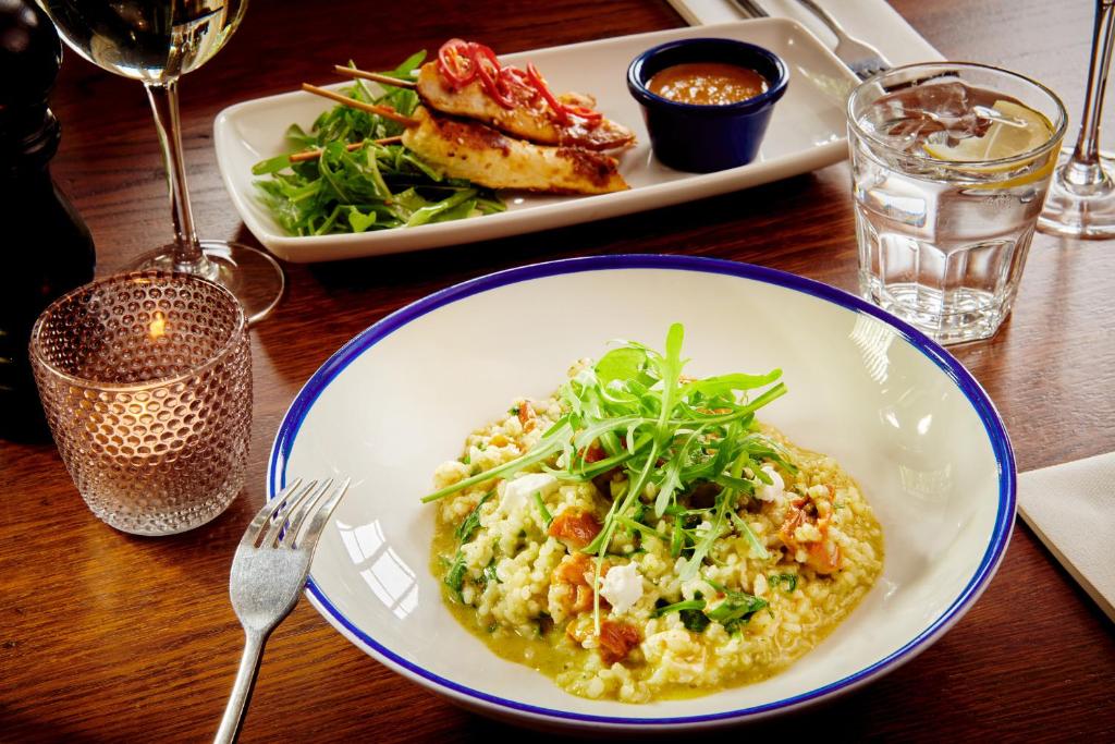 a table with two plates of food on a table at The Jug And Bottle in Heswall