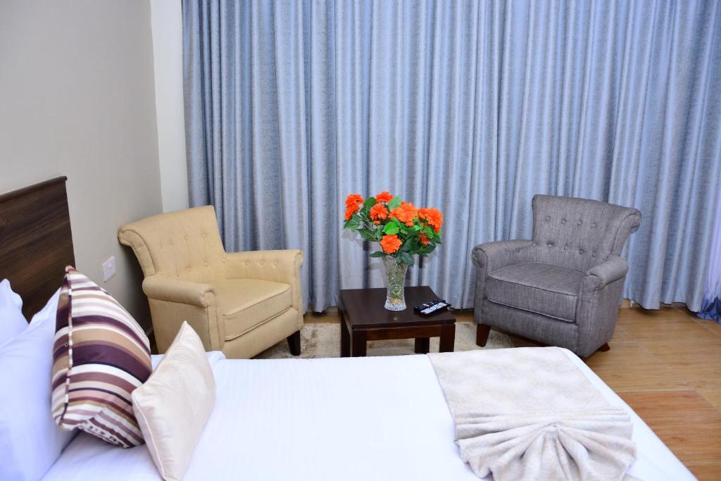 Postel nebo postele na pokoji v ubytování Razana Hotel
