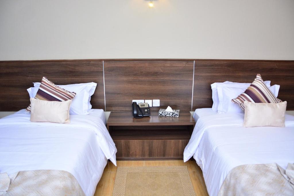Postel nebo postele na pokoji v ubytování Razana Hotel