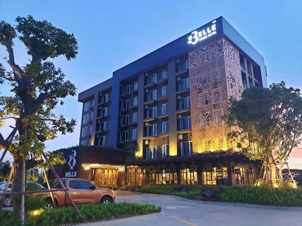 a building with a car parked in front of it at Belle Grand Hotel in Udon Thani