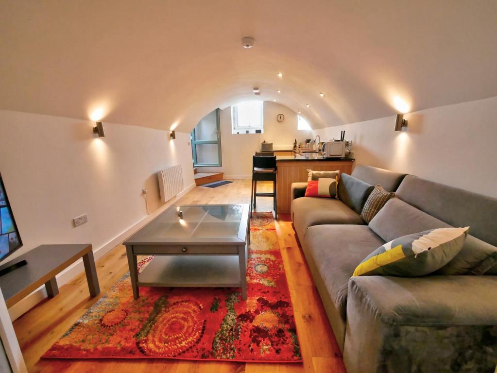 a living room with a couch and a table at Pell Dell Apartment in Holmfirth