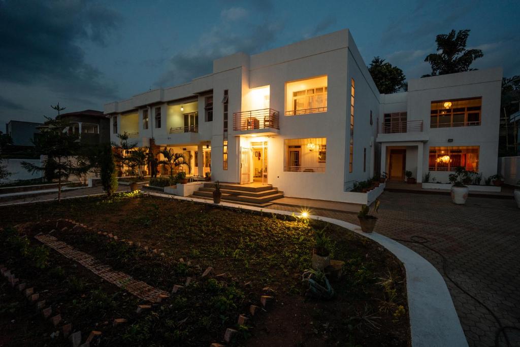 a large white house at night with lights at OMX Hotel Kimi in Kigali