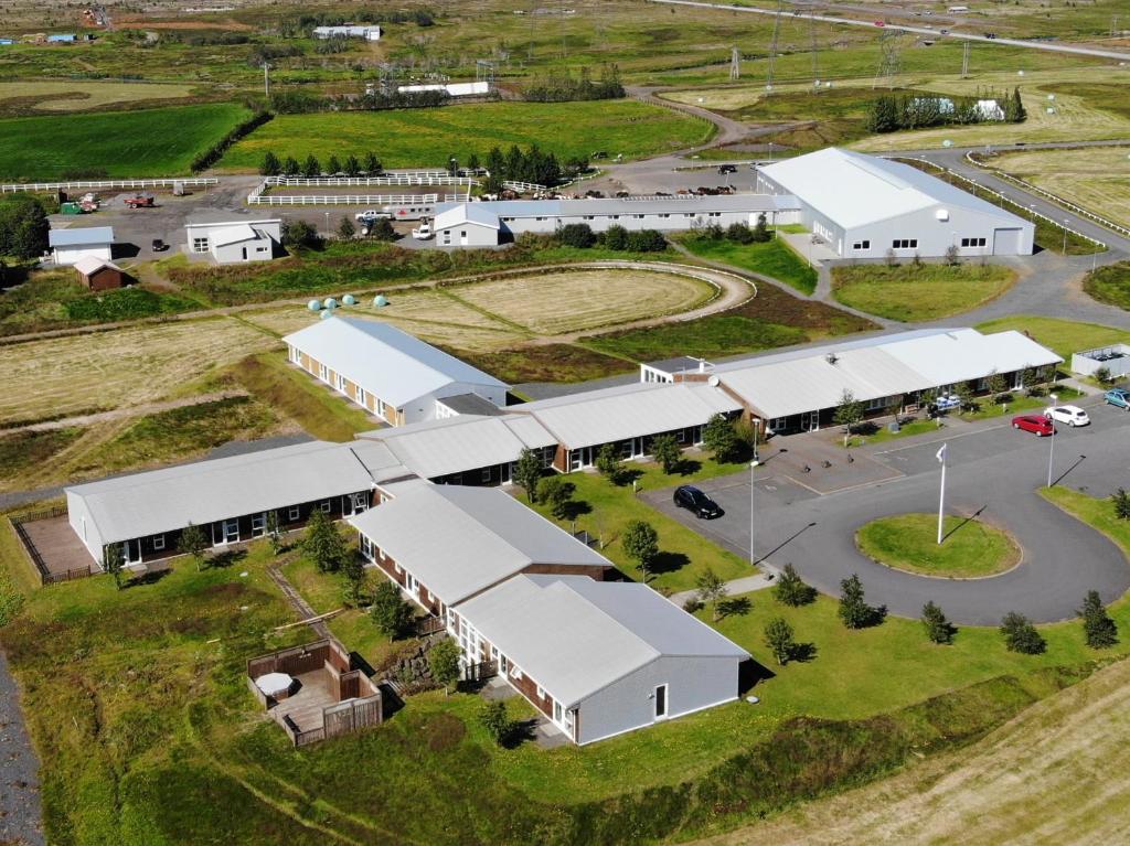 an aerial view of a farm with white buildings at Hótel Eldhestar in Hveragerði