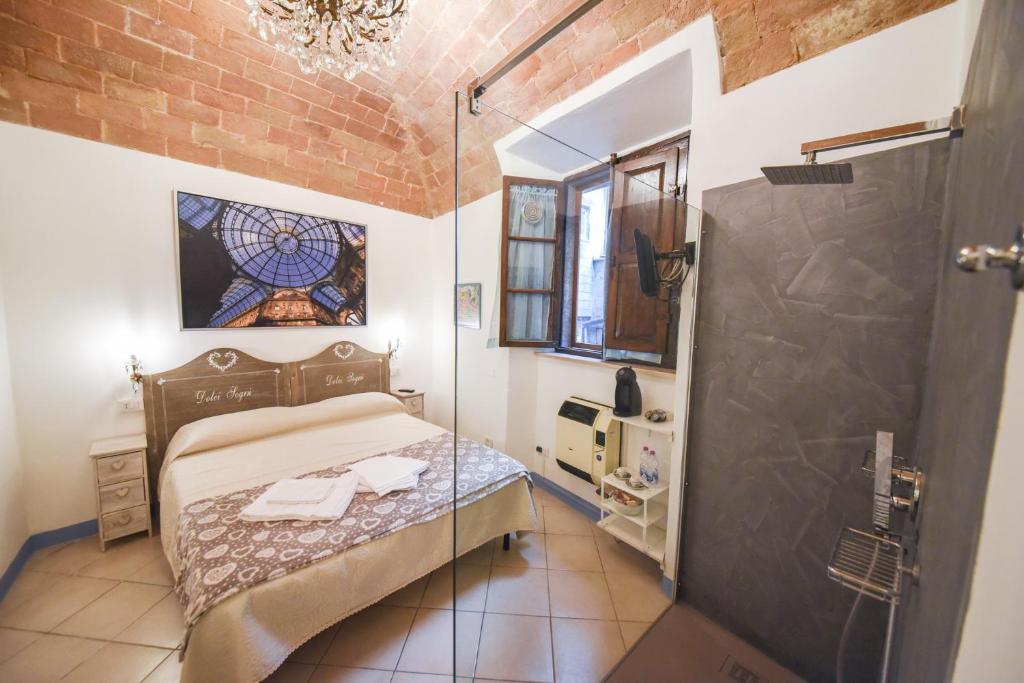 a small bedroom with a bed and a shower at Il Sogno di Annalisa il Nido in Volterra