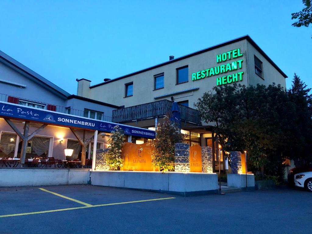 a hotel with a hotel restaurant next to a parking lot at Hotel Hecht in Sennwald