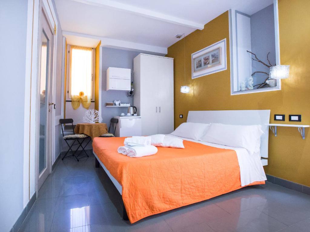 Postel nebo postele na pokoji v ubytování I Coralli rooms & apartments