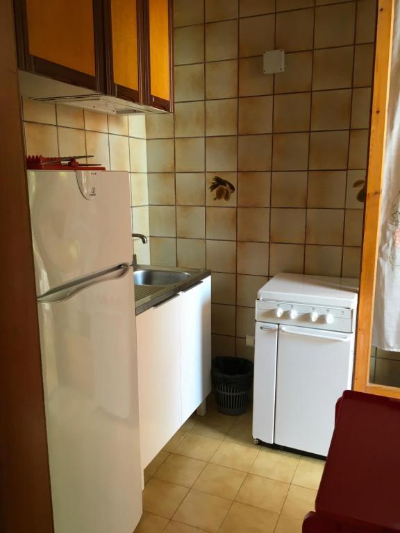 a kitchen with a white refrigerator and a sink at Appartamenti Santa Margherita in Vieste