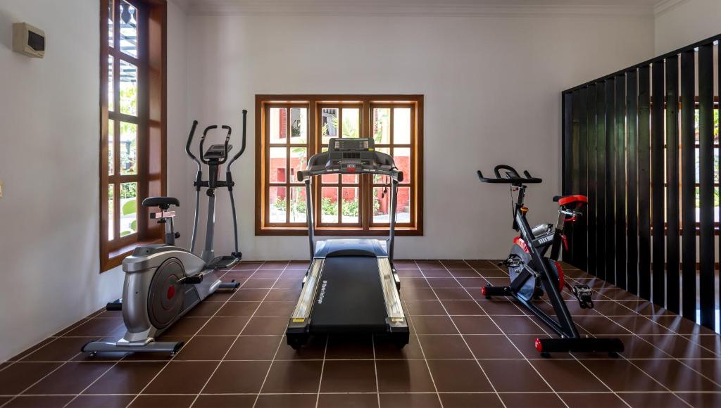 a gym with two treadmills and two exercise bikes at La Rivière d' Angkor Resort in Siem Reap