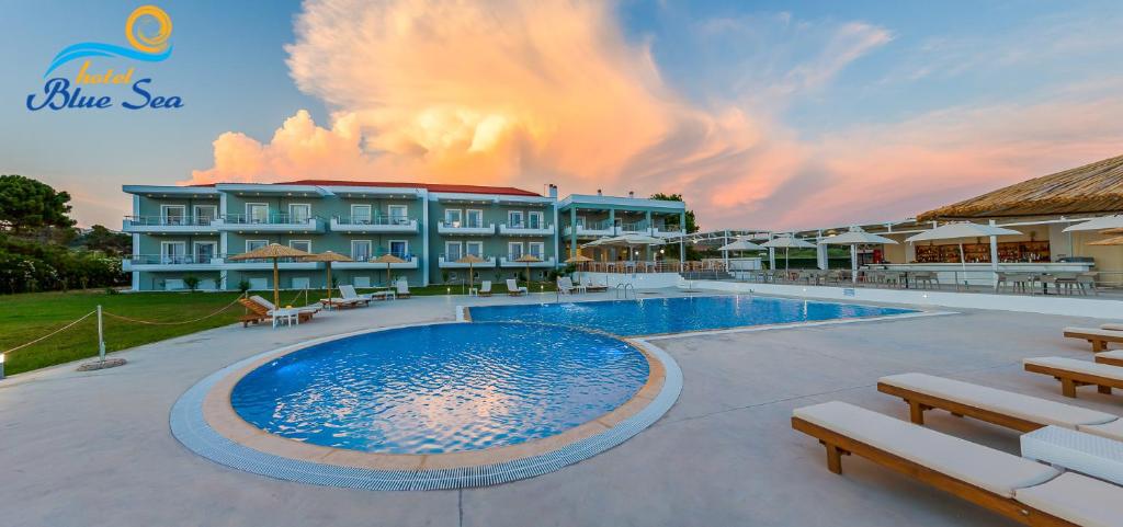 a large swimming pool in front of a building at Blue Sea Hotel in Kanali