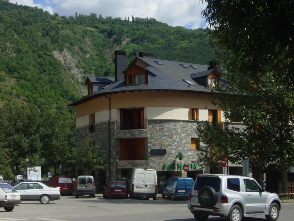 a building with a roof with cars parked in a parking lot at B16 - Edif Ball Benás Dúplex - Villmor in Benasque