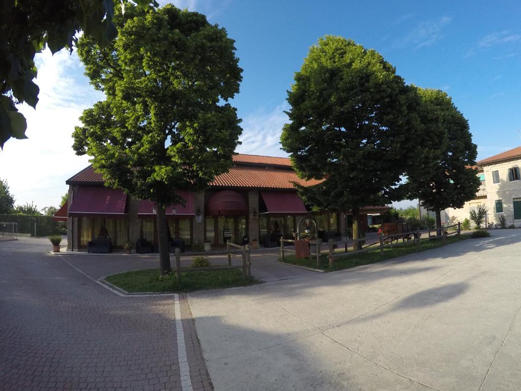 a building with trees in front of a street at Agriturismo La Rebosola in Ca Zennare