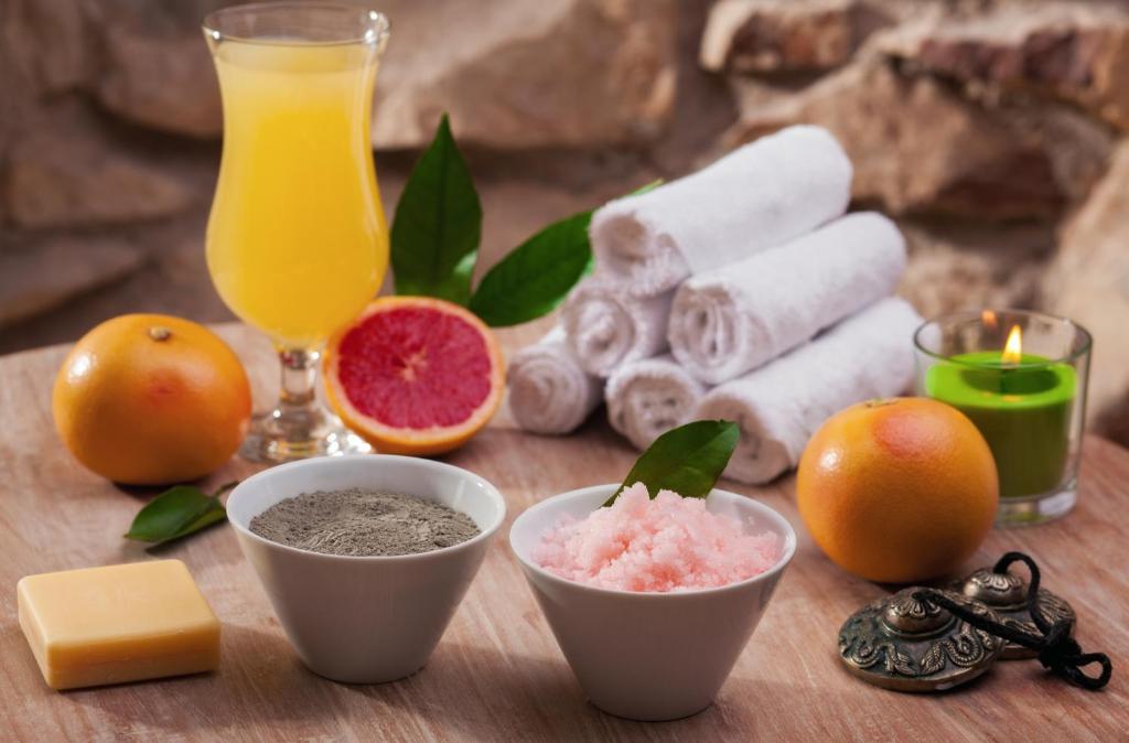 a table with some fruit and a glass of orange juice at Alchymist Grand Hotel and Spa - Preferred Hotels & Resorts in Prague