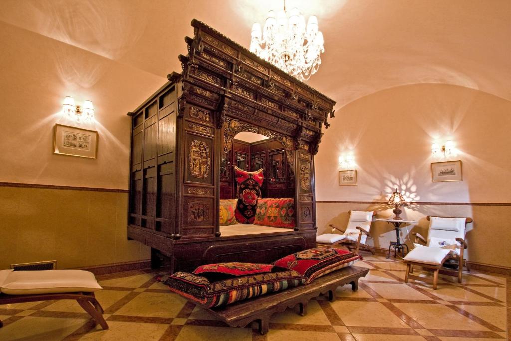 a bedroom with a large wooden bed in a room at Alchymist Grand Hotel and Spa - Preferred Hotels & Resorts in Prague