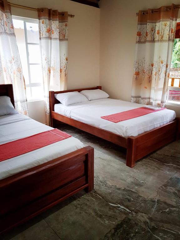 Postel nebo postele na pokoji v ubytování Coco Loco Lodge