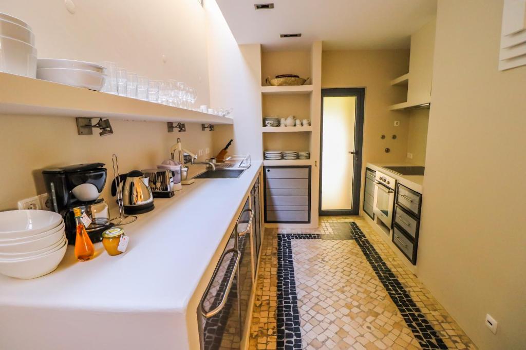 a kitchen with a counter and a tile floor at Villa Zawaia B&B in Lagos