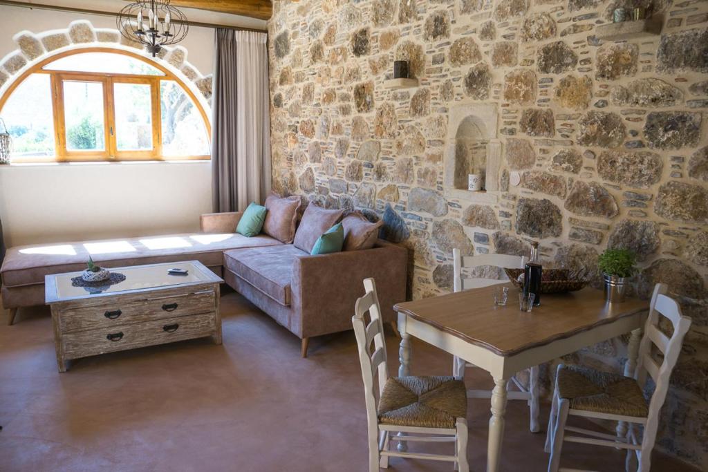 a living room with a couch and a table at To Spiti mas in Sougia