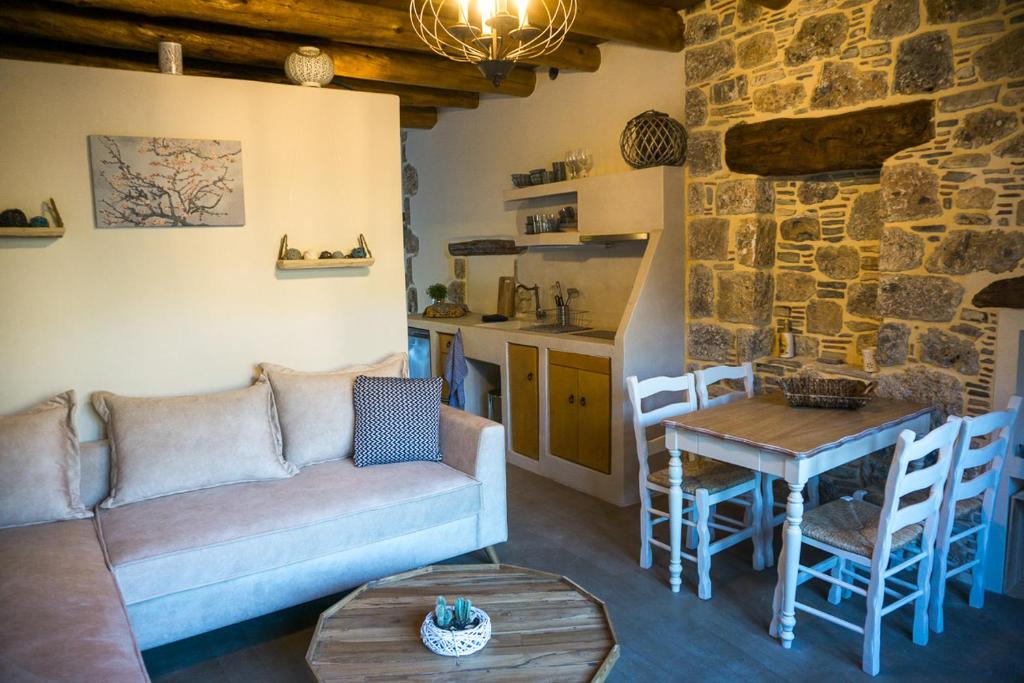 a living room with a couch and a table at To Spiti mas in Sougia